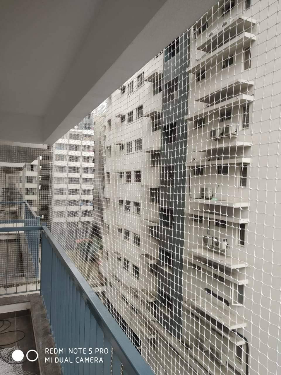 Pigeon safety net fitted across an apartment balcony opening in Hyderabad