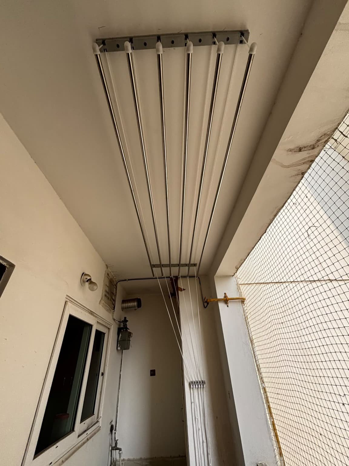Cloth hanger repair enquiry: existing ceiling mounted metal drying rods and pulley cords in Lanco Hills Manikonda Hyderabad balcony